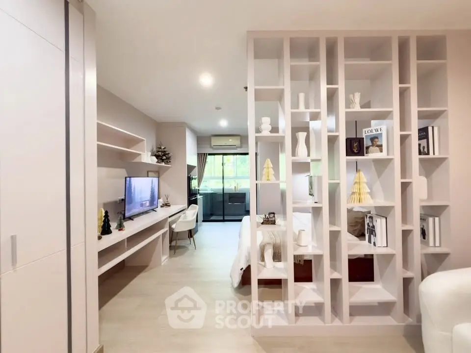 Modern open-plan living room with stylish partition and natural light