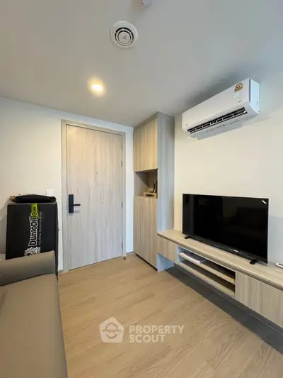 Modern living room with sleek furniture and air conditioning in a stylish apartment.