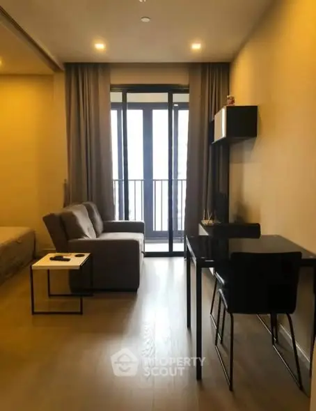 Modern living room with cozy sofa and study desk near balcony