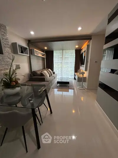Modern living room with sleek design and natural light, featuring a cozy sofa and stylish decor.