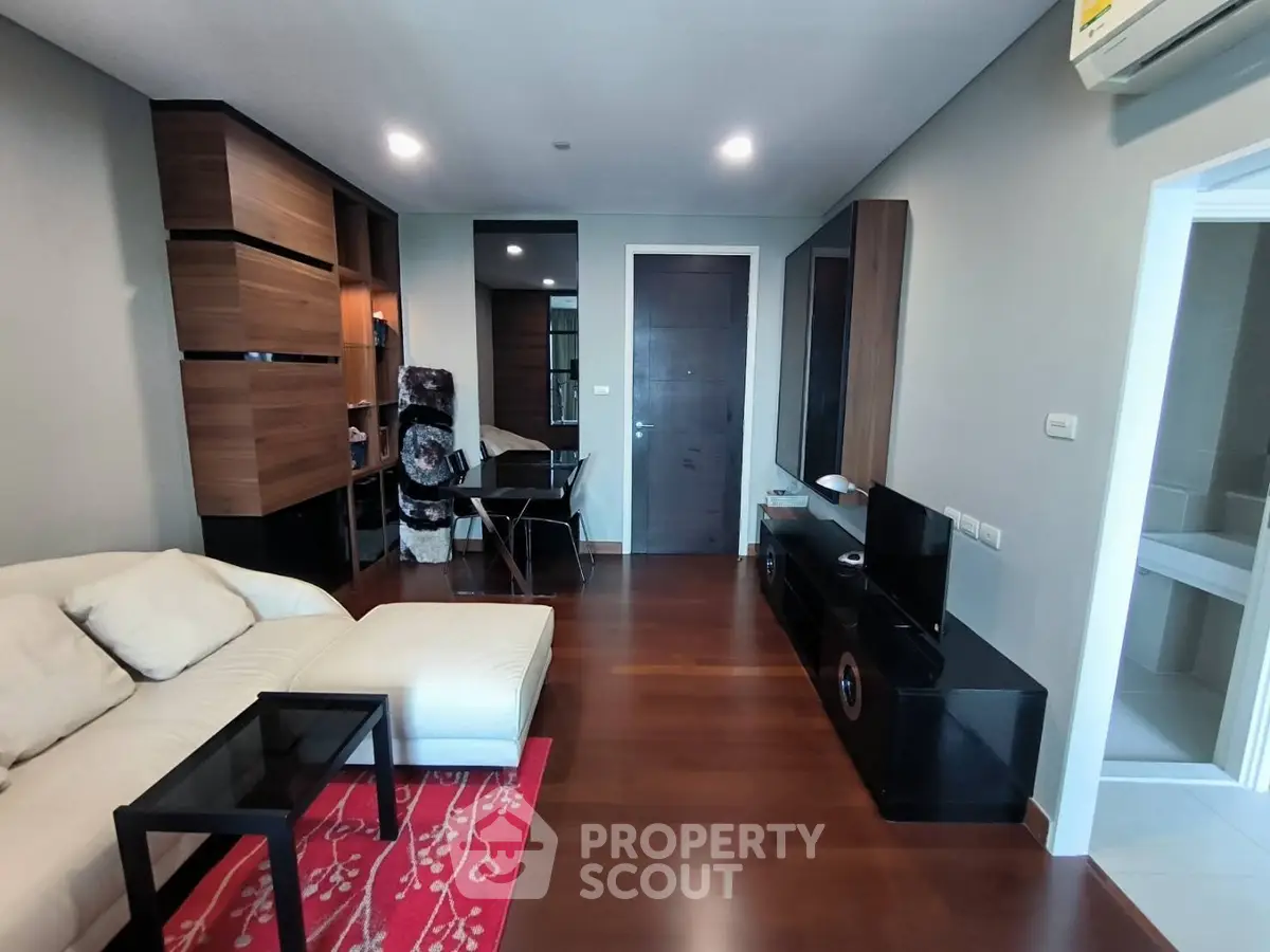 Modern living room with wooden flooring and stylish furniture in a cozy apartment.