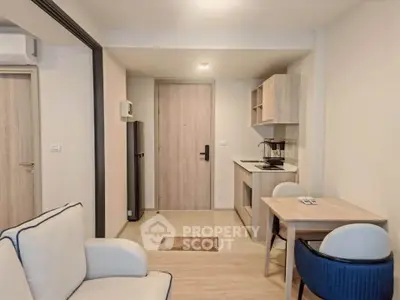 Modern compact living space with kitchenette and cozy dining area