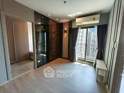 Modern living room with balcony access and stylish wood flooring