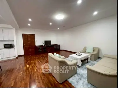 Spacious living room with elegant hardwood flooring and cozy seating area.