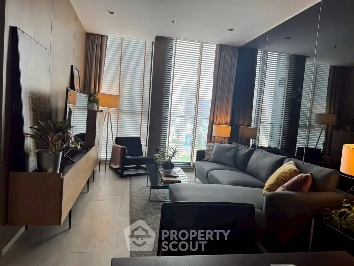 Modern living room with floor-to-ceiling windows and stylish decor