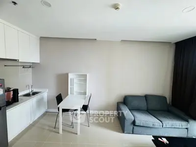 Modern studio apartment with compact kitchen and cozy living area