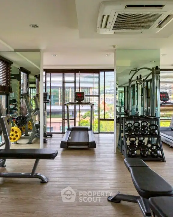 Modern gym with state-of-the-art equipment and scenic views in luxury property.