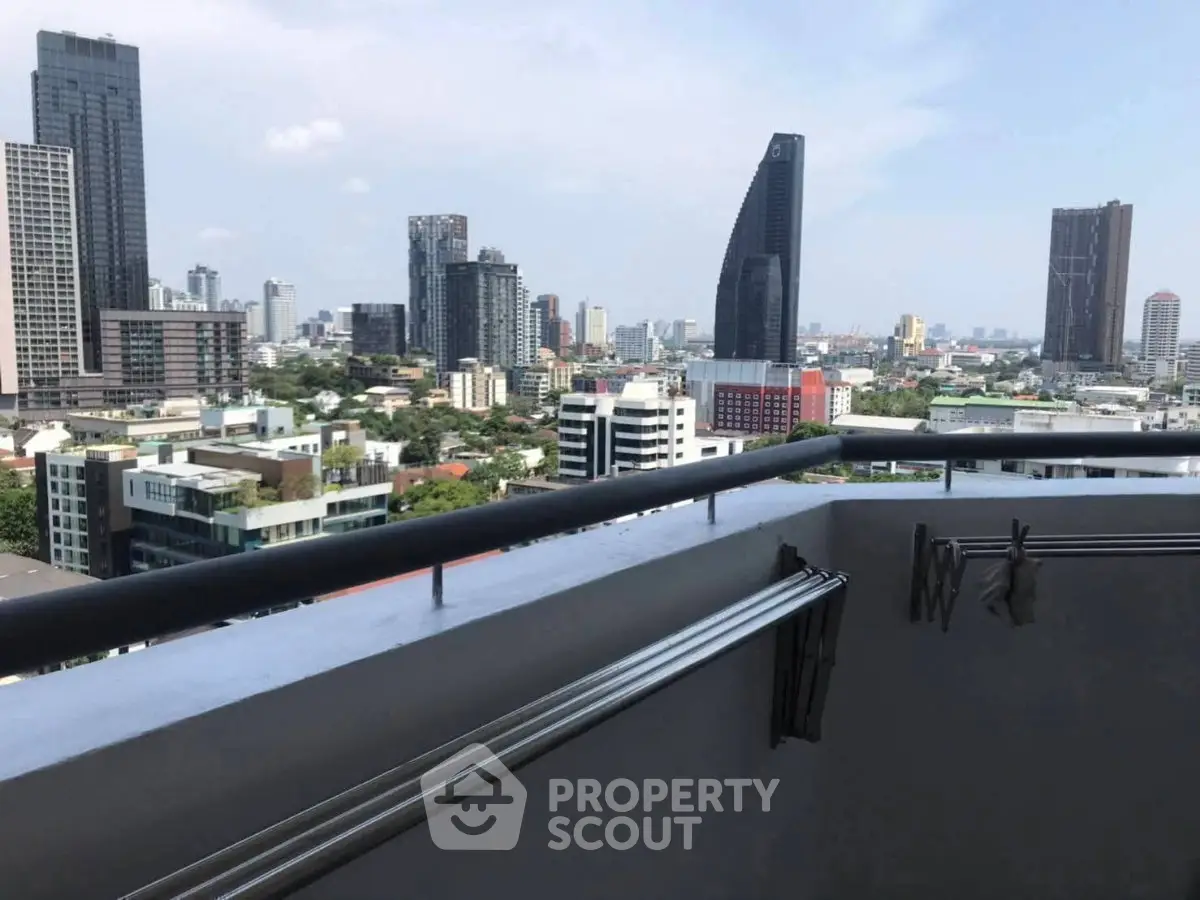Stunning cityscape view from a high-rise balcony in a modern urban setting.