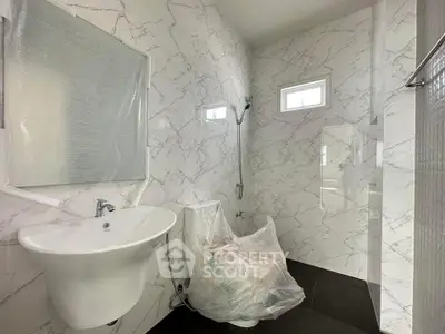 Modern bathroom with marble walls and sleek fixtures