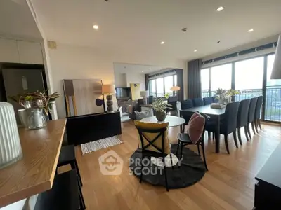 Spacious modern living and dining area with large windows and stylish decor