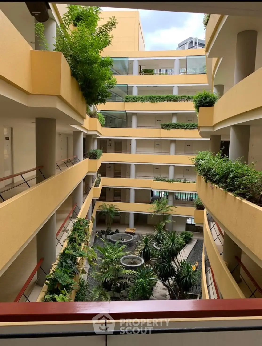 Stunning multi-level building with lush interior garden and modern design.