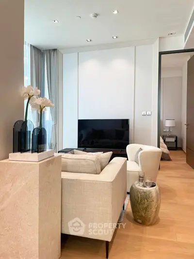 Elegant living room with modern decor and natural light, featuring a cozy sofa and stylish accents.