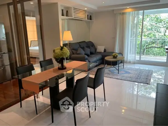 Modern living room with elegant dining area and balcony view