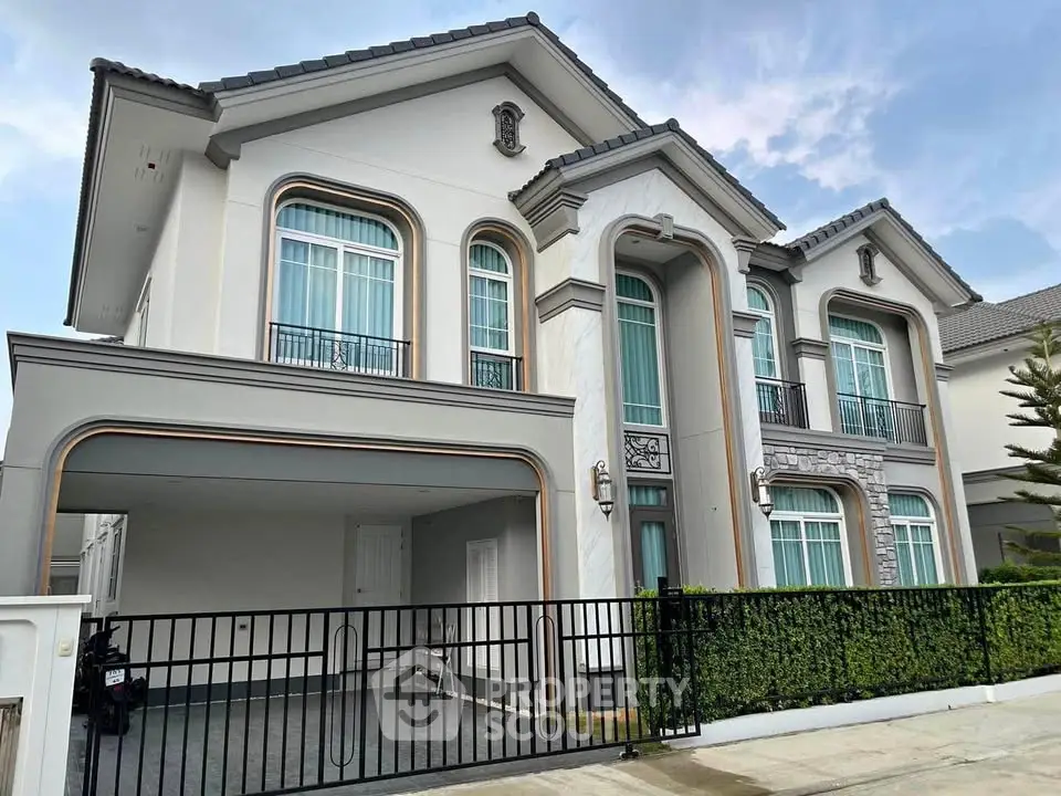 Elegant two-story house with modern architecture and spacious driveway in a serene neighborhood.