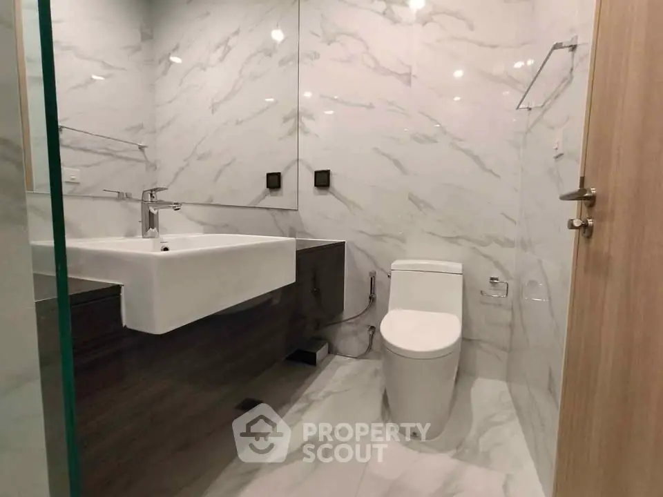 Modern bathroom with sleek fixtures and marble walls