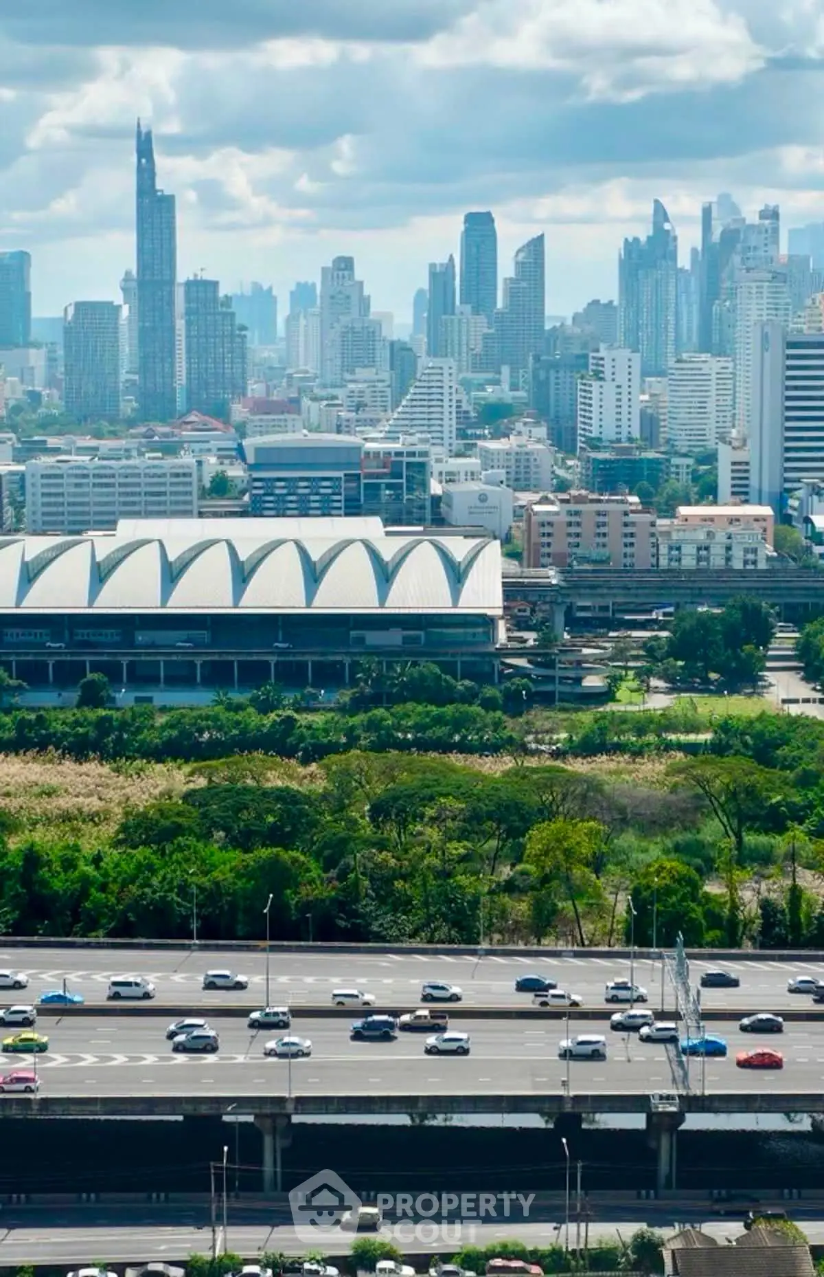 Stunning cityscape view with lush greenery and modern skyline, perfect for urban living enthusiasts.