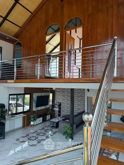Stunning modern loft with high ceilings and elegant wooden finishes, featuring a spacious living area and stylish staircase.