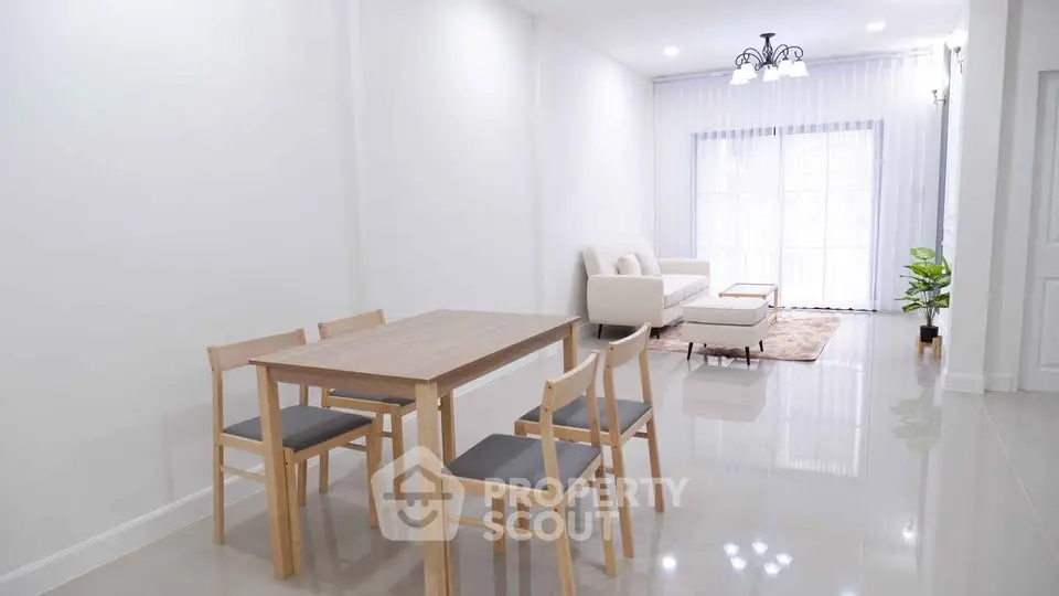 Modern open-plan living and dining area with sleek furniture and bright natural light.