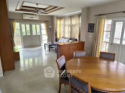 Spacious living room with elegant dining area and abundant natural light.
