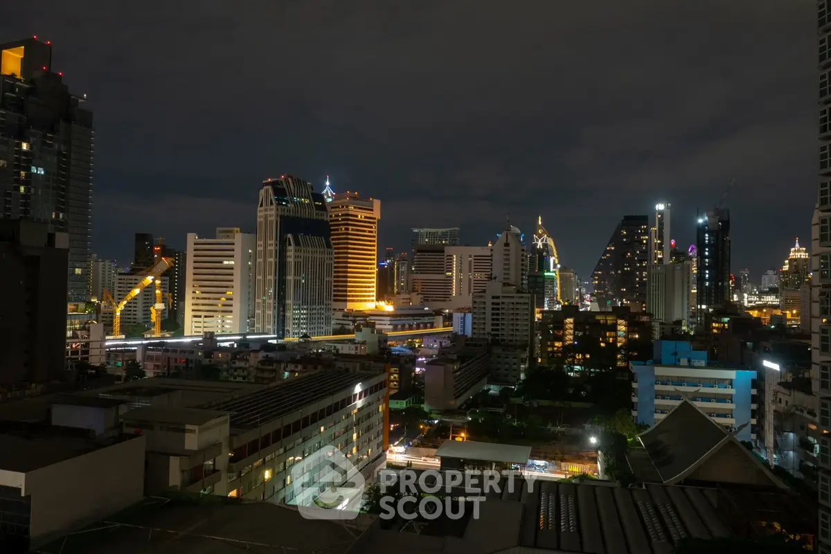 Stunning cityscape view of illuminated skyscrapers at night, showcasing urban living and architectural marvels.