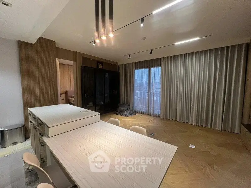 Modern living room with elegant lighting and floor-to-ceiling curtains