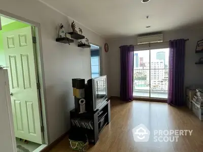 Spacious living room with hardwood floors, ample natural light, and a charming city view through large windows, complemented by elegant purple drapes.