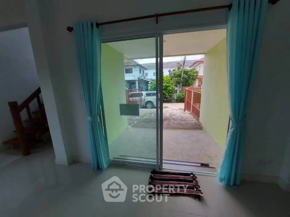 Spacious living area with sliding glass doors leading to a private driveway, perfect for family gatherings.