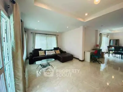 Spacious living room with modern decor and ample natural light