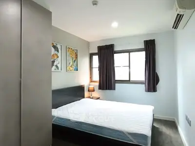 Cozy bedroom with modern decor and ample natural light