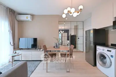 Modern living room with dining area, featuring sleek furniture and appliances in a stylish open layout.