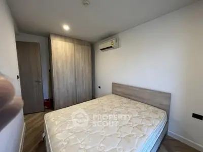 Cozy bedroom with modern air conditioning and wooden wardrobe