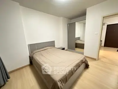 Modern minimalist bedroom with mirrored closet and neutral tones.