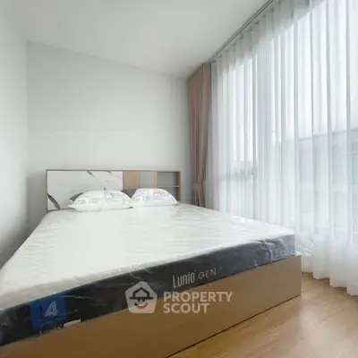 Bright and airy bedroom with large window and modern furnishings