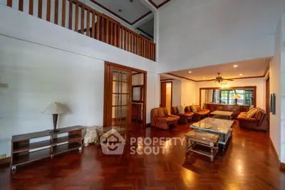 Spacious living room with high ceilings and elegant wooden flooring