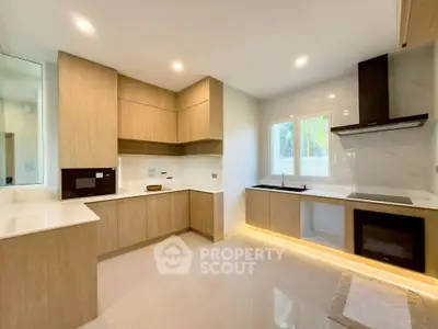 Modern kitchen with sleek wooden cabinets and built-in appliances