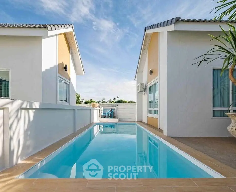 Stunning modern villa with private pool and sleek architecture under a clear blue sky.