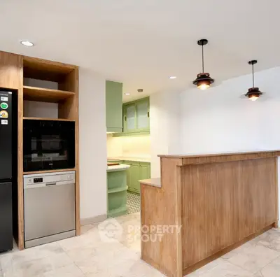 Modern kitchen with open layout and stylish wooden bar counter
