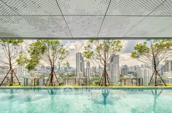 Stunning rooftop pool with panoramic city skyline views and lush greenery.