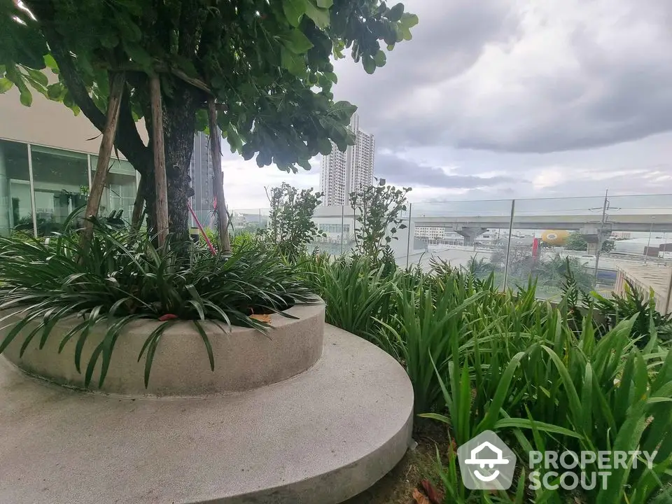 Stunning garden view with lush greenery and cityscape backdrop, perfect for urban relaxation.