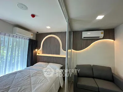 Modern bedroom with stylish lighting and cozy seating area