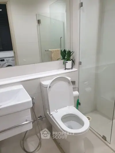 Modern bathroom with sleek fixtures and glass shower enclosure