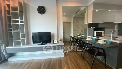 Modern living room with sleek kitchen and stylish decor