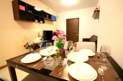 Elegant dining space seamlessly connects to a cozy living area, perfect for intimate dinners and relaxing evenings, featuring modern furnishings and tasteful decor.