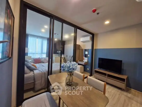 Modern apartment interior with dining area and bedroom view