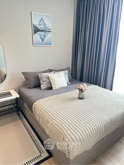 Cozy bedroom with elegant decor and soft lighting, featuring a comfortable bed and stylish curtains.