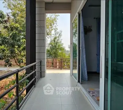 Spacious balcony with sliding glass doors and scenic view