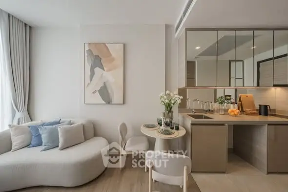 Modern living room with cozy seating and stylish kitchen area