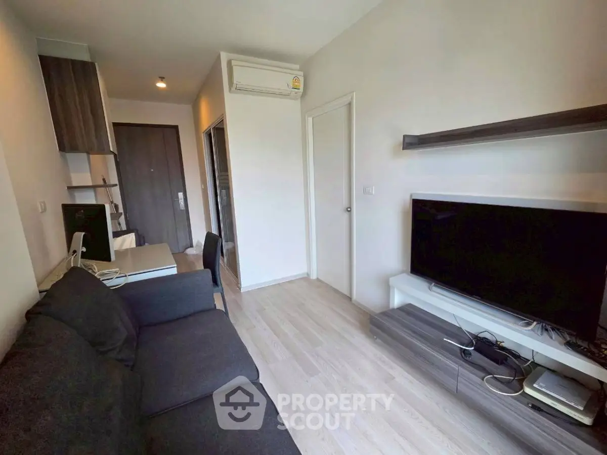 Modern living room with sleek furniture and entertainment setup in a stylish apartment.