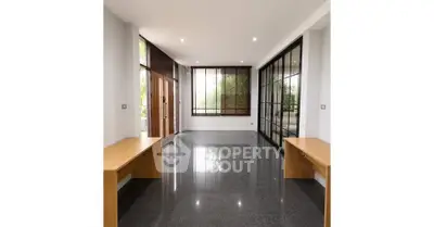 Spacious modern living room with large windows and sleek flooring