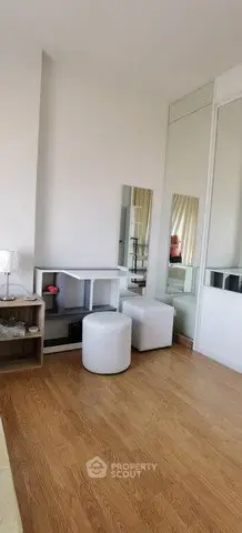 Modern bedroom corner with wooden flooring and stylish furniture